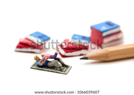 Miniature people : Father and son playing with book,enjoy and education concept.