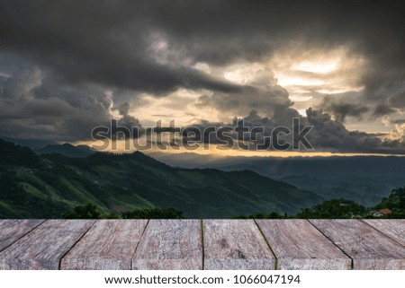 An empty grid of wood in front of the mountain and cloud background can be used to display or edit your product for display of the product.