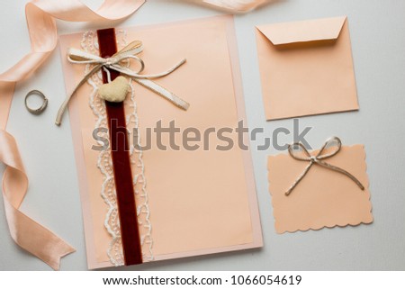 Workspace. Wedding invitation cards, peach envelopes, ribbons, ink pen on white background. Overhead view. Flat lay, top view invitation card. copy space. mockup