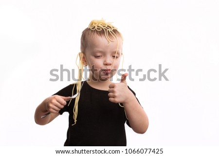 Deception, noodles on the ears. A boy in a black T-shirt is not a white isolated background. April Fools Day concept.