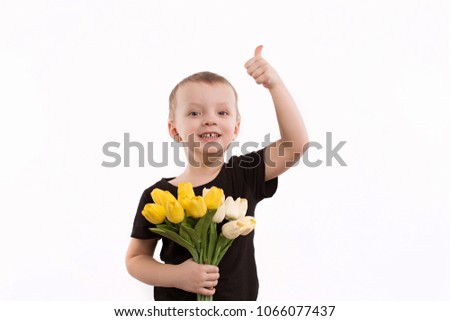Young boy holding tulips isolated on white