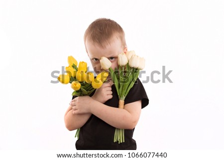 Young boy holding tulips isolated on white
