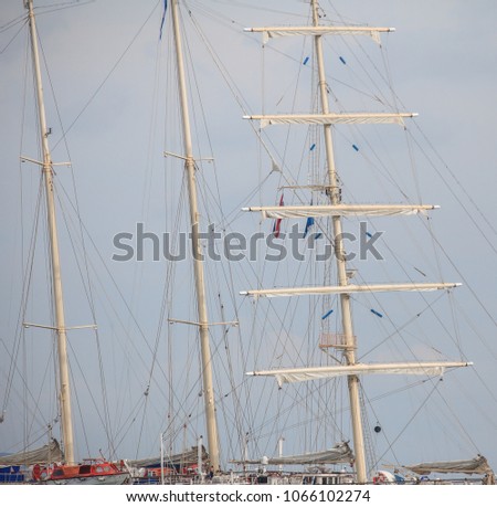 Sailing masts and ropes in the sea with sky background