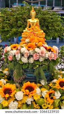 Golden Buddha with flowers, sunflower