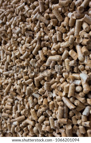 Wooden pet bedding vertical background. Wood pellets texture.