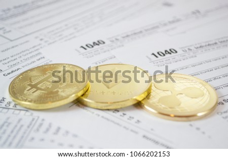 Bitcoin and alternate cryptocurrencies coin symbol on tax form, crypto currency sign, future technology financial concept