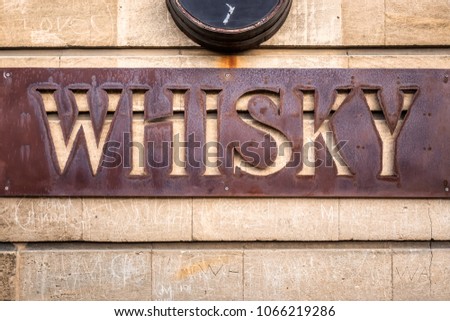 Old rusty whiskey sign at Oamaru in the South Island of New Zealand. Omaru is home to the steam punk.