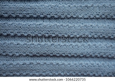 Horizontal ribs pattern on blue knitted fabric