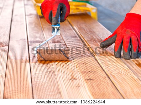 Painting a terrace board impregnation water proofing Royalty-Free Stock Photo #1066224644