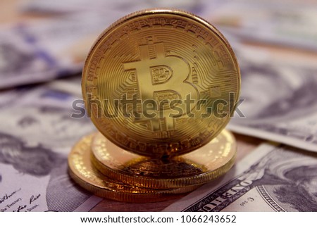 Bitcoin stacked on a background of dollar bills. Exchange dollar to bitcoin.  