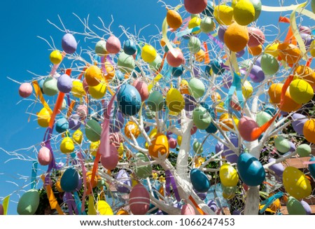 White spring tree with multicolored eggs on branches