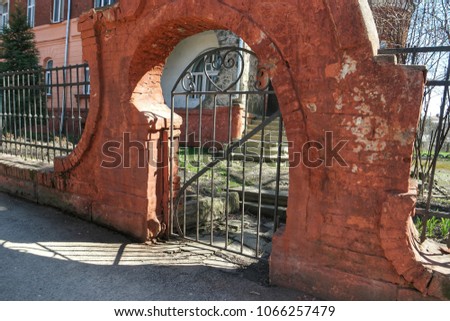  Ancient archway and forged fence  on the street of the city