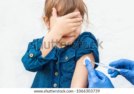 vaccination of children. An injection. Selective focus. Royalty-Free Stock Photo #1066303739