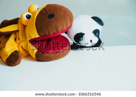 playing puppet on the white background. animal. reaction. Emotional.giraffe and panda.friends