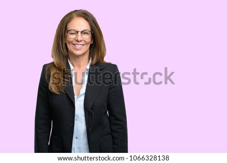 Middle age business woman blinking eyes with happy gesture