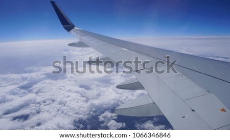 Photo of beautiful scattered clouds and clear blue sky as seen from a window plane on a lovely sunny morning              
