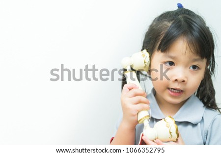 Adorable Asian little girl Talking on vintage classic telephone.