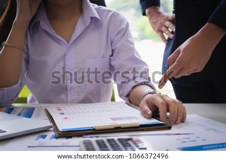 Female subordinate receiving reprimand from boss for being too late at meeting. Pointing on wristwatch. Time management and punctuality at work concept. Royalty-Free Stock Photo #1066372496