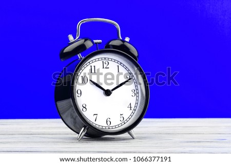 alarm clock on wooden boards