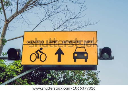 shared lane and beware bike warning sign