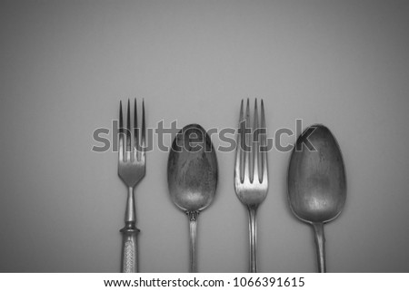 Vintage cutlery forks and spoons on an black  background