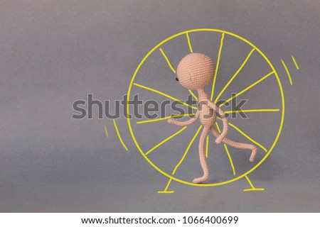 A toy man on a gray background with copy space. Presentation PowerPoint or Keynote. Motivational phrase. A sketch is drawn on top of the photo.Man running in a wheel