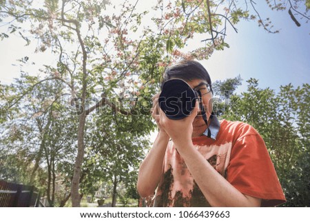 Asian man taking photography in garden