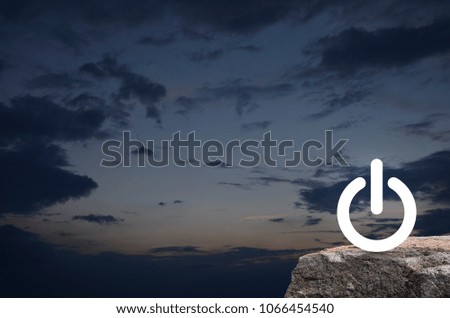 Power button icon on rock mountain over sunset sky, Start up business concept