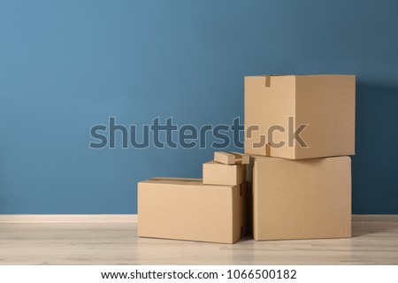 Cardboard boxes near color wall