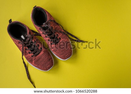 Sneakers on a yellow background top view copy space.