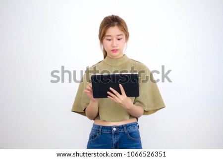 Portrait of thai china adult beautiful girl using her tablet.