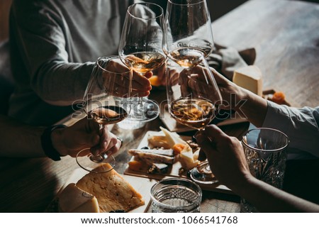 Wine and cheese served for a friendly party in a bar or a restaurant. Royalty-Free Stock Photo #1066541768