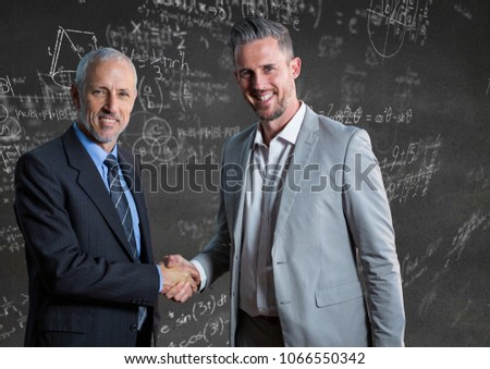Business men shaking hands against grey wall with math doodles