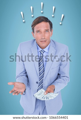 Frustrated business man with money against blue background and exclamation points