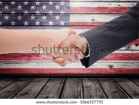 People shaking theur hands against american flag