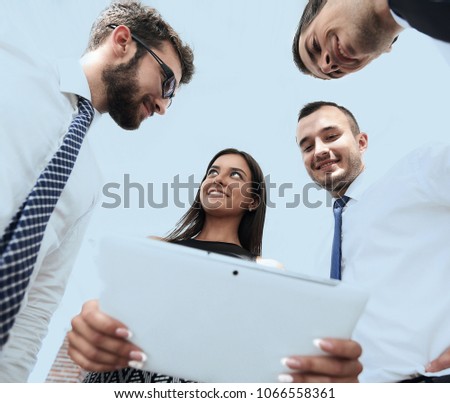 bottom view of business team looking at digital tablet