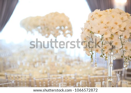 White round reception table with flowers and chairs