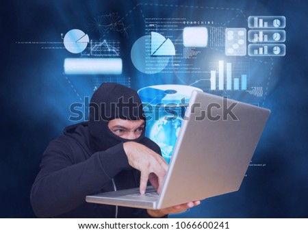 Hacker with hood working on a laptop in front of blue digital background