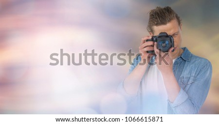 Photographertaking picture against glowing background