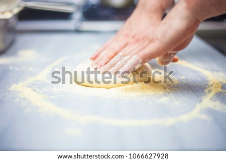 Chef prepares Pizza Dough for order