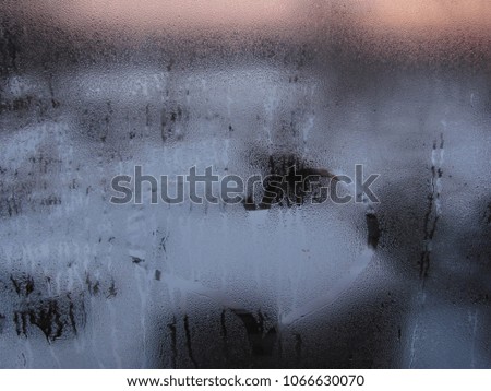  blurred winter landscape through the misted window