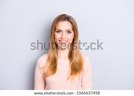 Close up front view portrait of cute lovely sweet adorable charming joyful cheerful rejoicing with beaming shiny smile woman wearing light peachy pink sweater pullover isolated on gray background