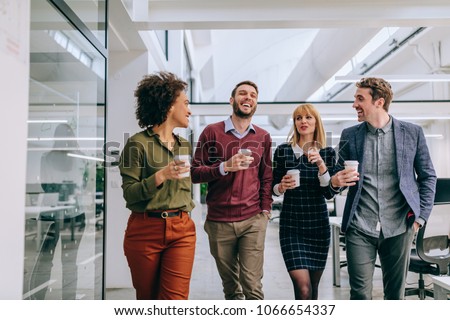 Group of coworkers having a coffee break Royalty-Free Stock Photo #1066654337