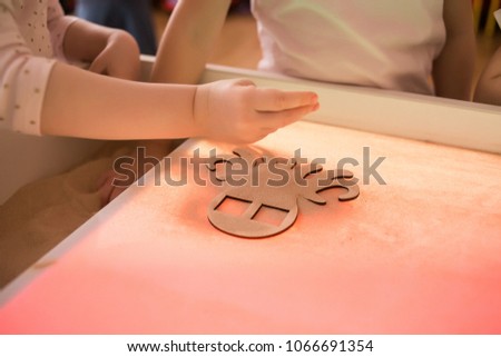 Children paint in the interactive sand table , sand animation