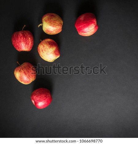 on a dark black background red yellow apples frame view from above flat lay square