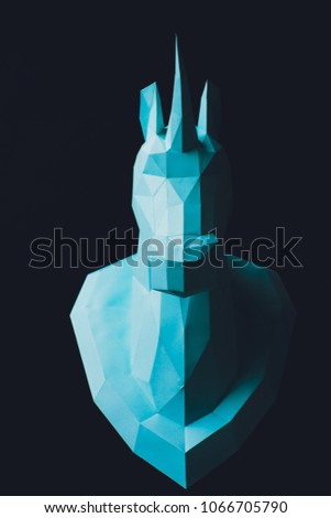 Unicorn turquoise head paper isolated on black background. Copy space.