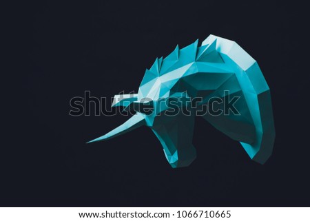 Unicorn turquoise head paper isolated on black background. Copy space.