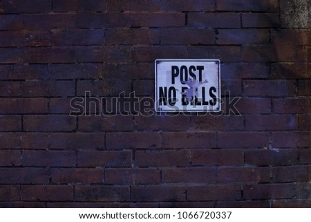 Post No Bills sign on brick wall.