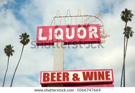 aged and worn liquor store sign with palm trees                              