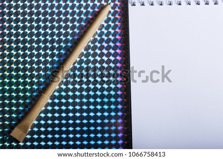 beige pen and white notebook mock up design. bright colorful background. isolated
